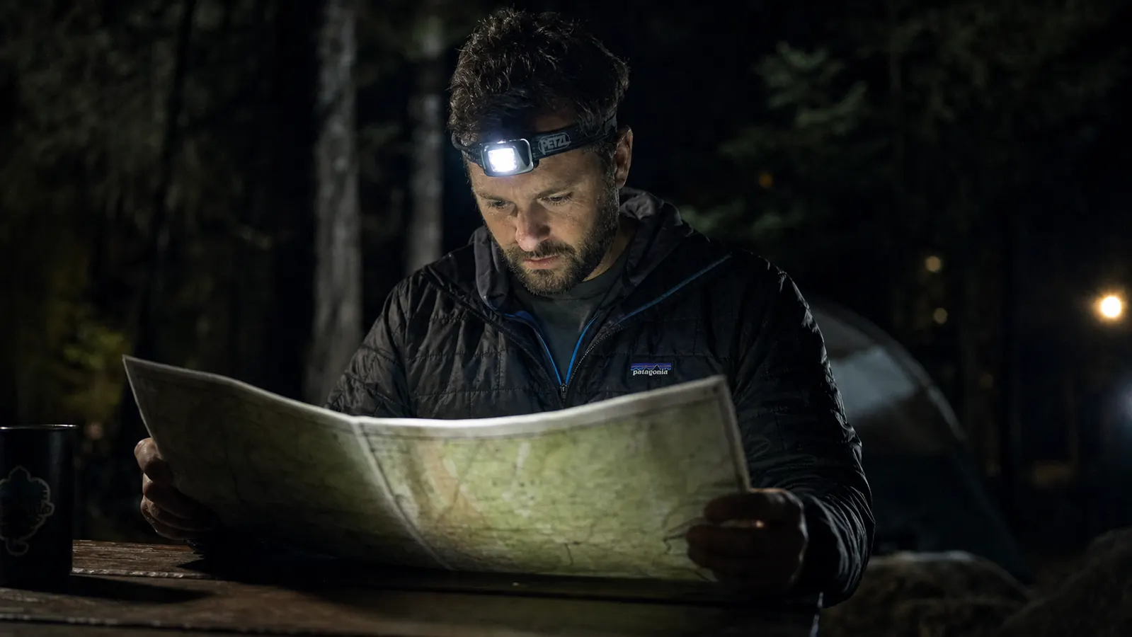 Split-scene showing LHKNL headlamp beam throw on a trail at night versus flood spread at a campsite table